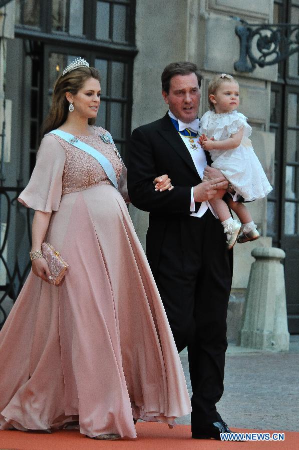 Sweden's Princess Madeleine, her husband Christopher O'Neill and their daughter Princess Lenore walk on their way to attend the wedding ceremony of Sweden's Prince Carl Philip and Sofia Hellqvist at the Raoyal Chapel at Stockholm Palace in Stockholm, Sweden, June 13, 2015.