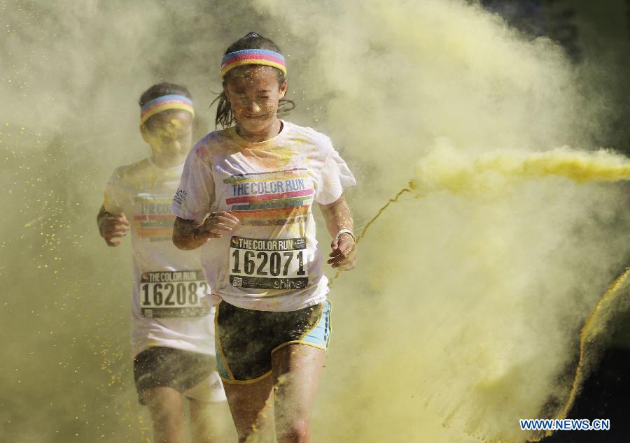 Runners are sprayed with colour powder during the colour run held in Vancouver, Canada, June 13, 2015.