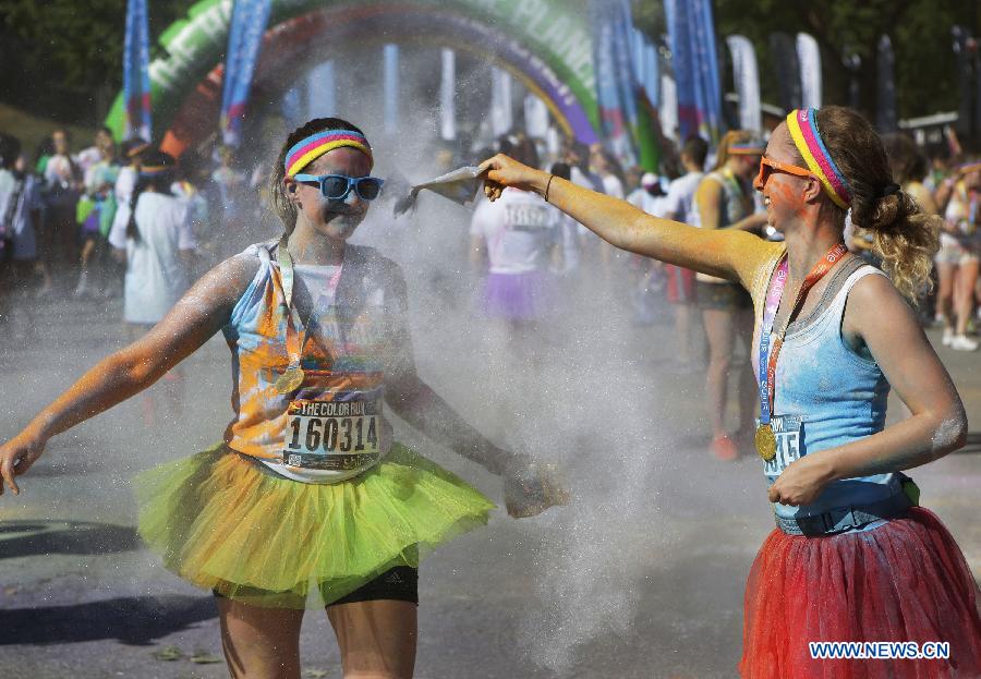 Runners spray colour powder to each other during the colour run held in Vancouver, Canada, June 13, 2015. 