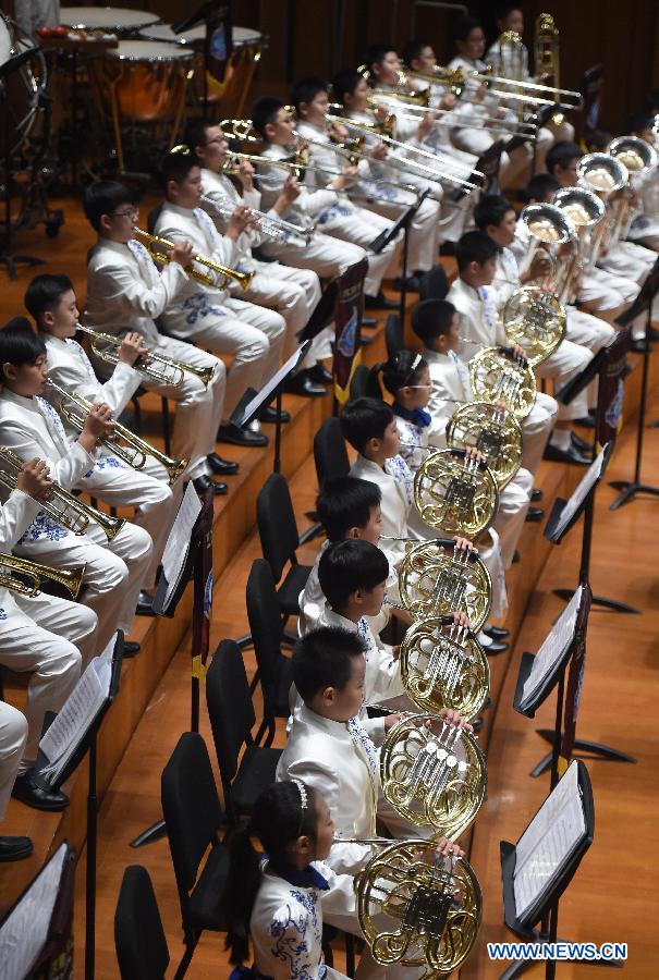 Bandsmen of a student wind band from Beijing No. 2 Experimental Primary School perform at the National Center for the Performing Arts in Beijing, capital of China, June 16, 2015. 