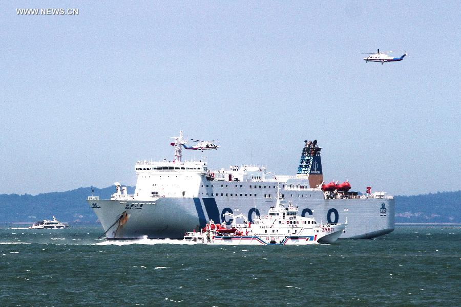 A passenger vessel takes part in a rescue drill in Xiamen, southeast China's Fujian Province, June 15, 2015. 