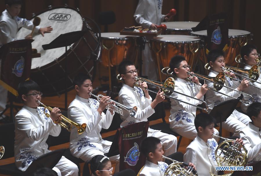 Bandsmen of a student wind band from Beijing No. 2 Experimental Primary School perform at the National Center for the Performing Arts in Beijing, capital of China, June 16, 2015.