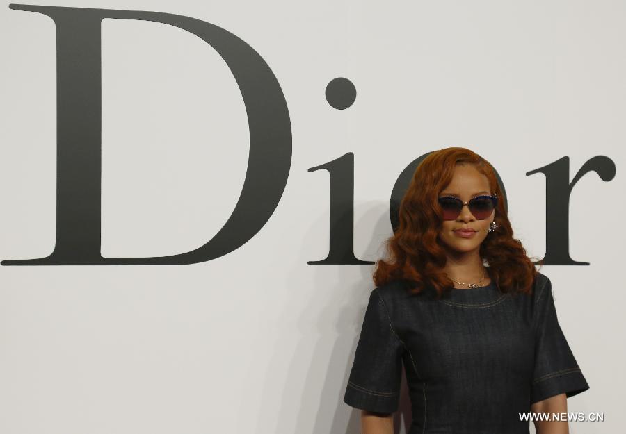 Singer Rihanna poses for pictures ahead of Christian Dior's 2015-16 fall/winter fashion show in Tokyo, on June 16, 2015. 