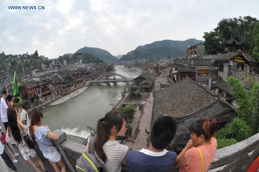 Photo taken on June 17, 2015 shows the ancient town of Fenghuang shrouded in fog in central China's Hunan Province. 