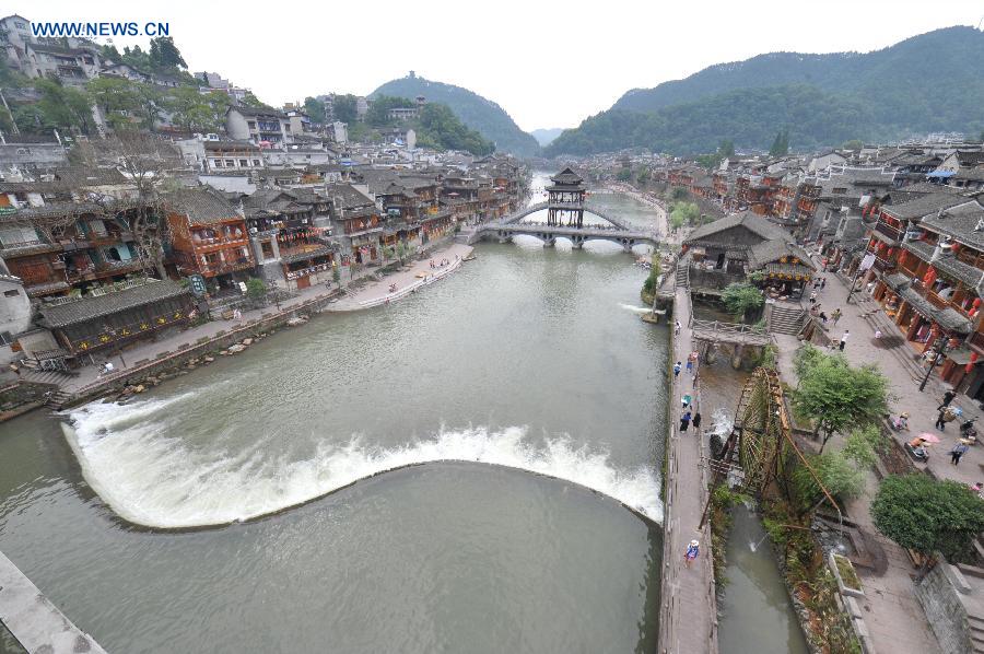 Photo taken on June 17, 2015 shows the ancient town of Fenghuang shrouded in fog in central China's Hunan Province. 