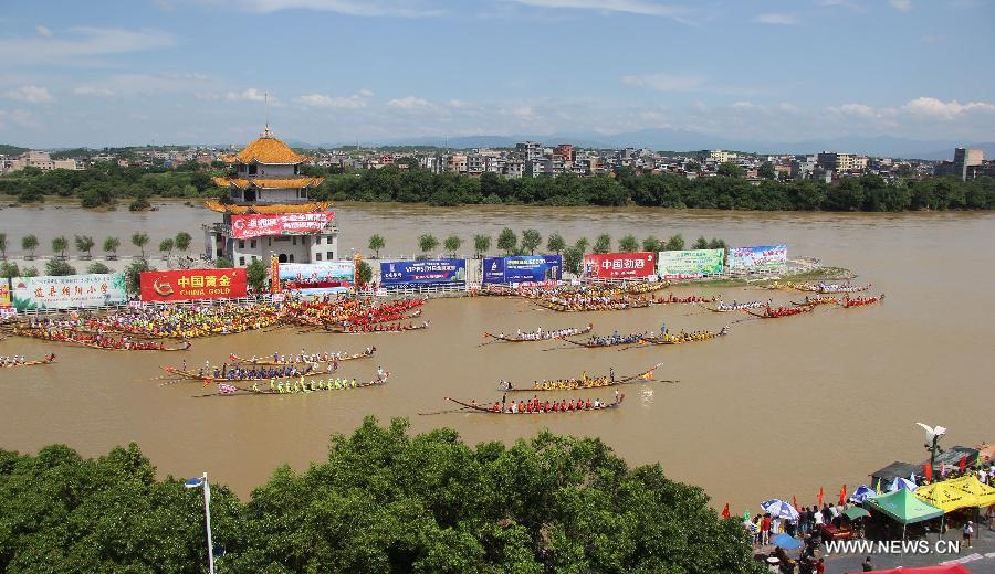 Competitors row dragon boats during a race held on the Xiaoshuihe River to celebrate the coming Dragon Boat Festival in Yongzhou, central China's Hunan Province, June 16, 2015. 