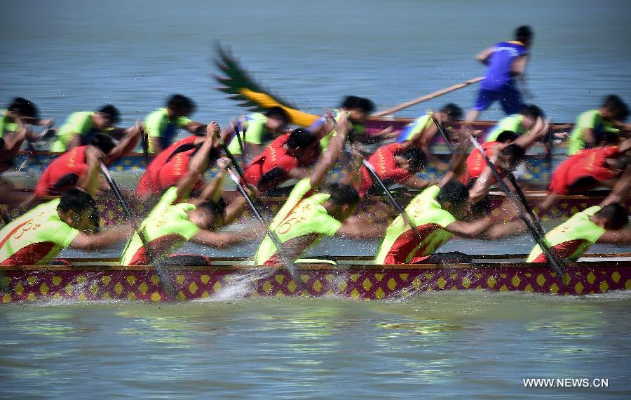 Participants compete in a dragon boat race in Chengmai, a county in south China's Hainan Province, on June 18, 2015. 