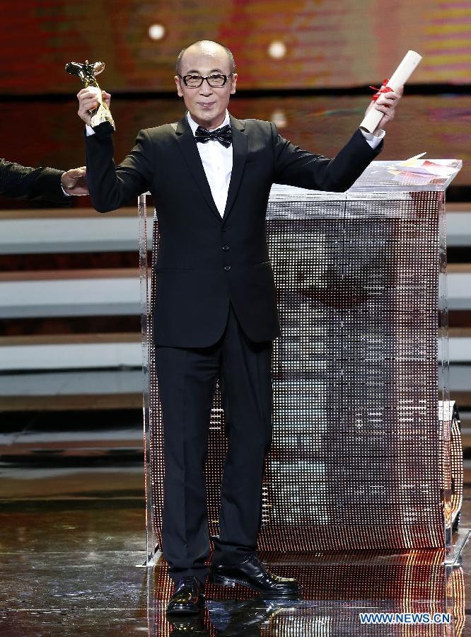 Cao Baoping, director of the film The Dead End, wins the Jinjue Award for Best Director during the awarding ceremony of the Shanghai International Film Festival, in Shanghai, east China, June 21, 2015. 