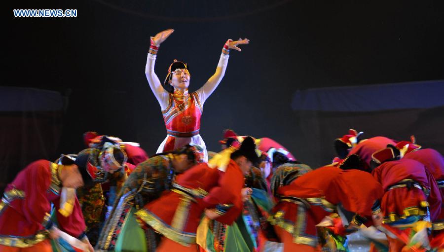 Dancers perform in a folk dance drama in Hohhot, capital city of north China's Inner Mongolia Autonomous Region, June 26, 2015.