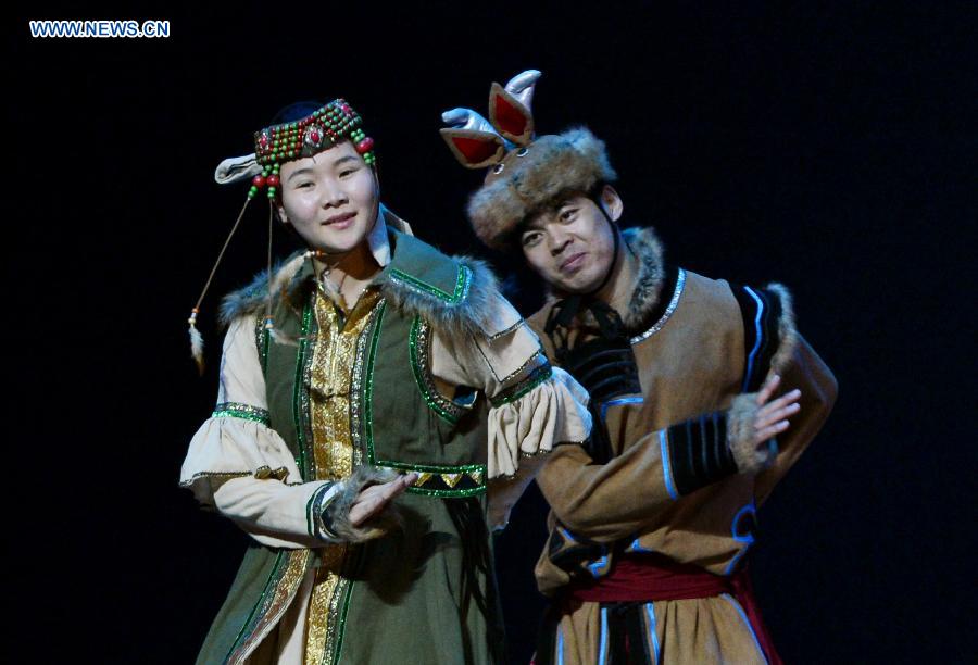 An actor and an actress perform in a folk dance drama in Hohhot, capital city of north China's Inner Mongolia Autonomous Region, June 26, 2015. 