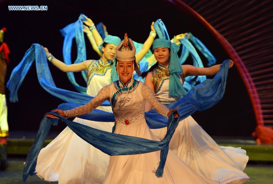 Dancers perform in a folk dance drama in Hohhot, capital city of north China's Inner Mongolia Autonomous Region, June 26, 2015. 