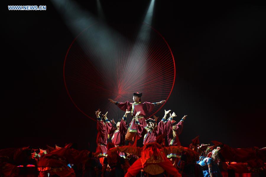 Dancers perform in a folk dance drama in Hohhot, capital city of north China's Inner Mongolia Autonomous Region, June 26, 2015.