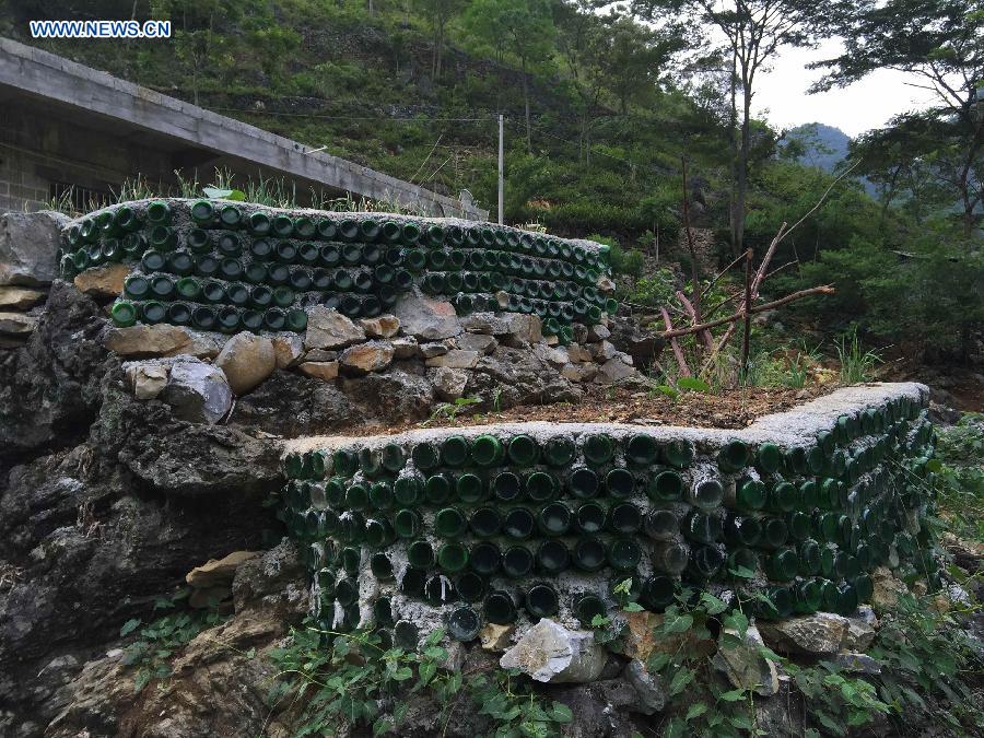 Photo taken on May 14, 2015 shows a vegetable field enclosed by rocks and beer bottles in Nongyong Village of Dahua Yao Autonomous County, south China's Guangxi Zhuang Autonomous Region.
