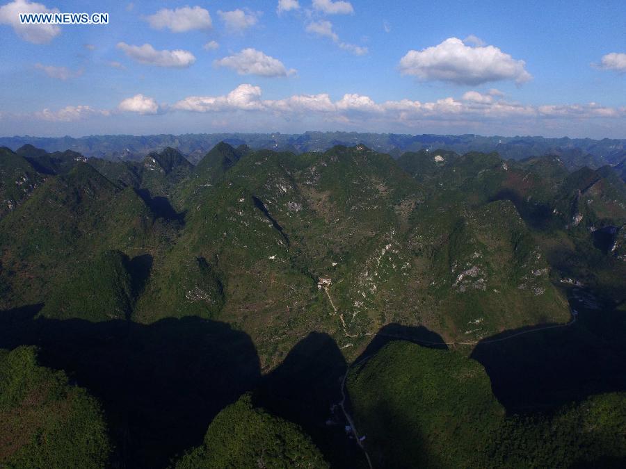 Photo taken on June 28, 2015 shows an aerial view of Nongyong Village among mountains in Dahua Yao Autonomous County, south China's Guangxi Zhuang Autonomous Region. 