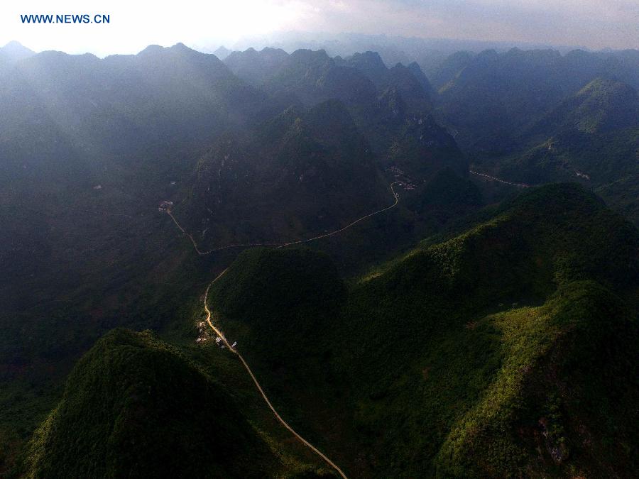 Photo taken on June 28, 2015 shows an aerial view of Nongyong Village among mountains in Dahua Yao Autonomous County, south China's Guangxi Zhuang Autonomous Region. 