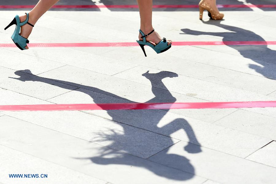 Participants run during a 'High Heels Race' in Taiyuan, capital of north China's Shanxi Province, July 3, 2015. 