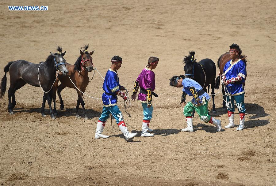 Artists perform in a race course in Hohhot, capital of north China's Inner Mongolia Autonomous Region, July 8, 2015. 