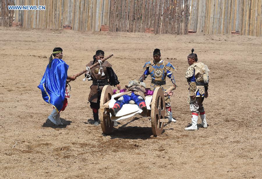 Artists perform in a race course in Hohhot, capital of north China's Inner Mongolia Autonomous Region, July 8, 2015.