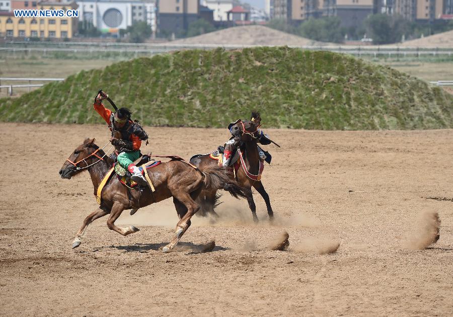 Artists perform in a race course in Hohhot, capital of north China's Inner Mongolia Autonomous Region, July 8, 2015.