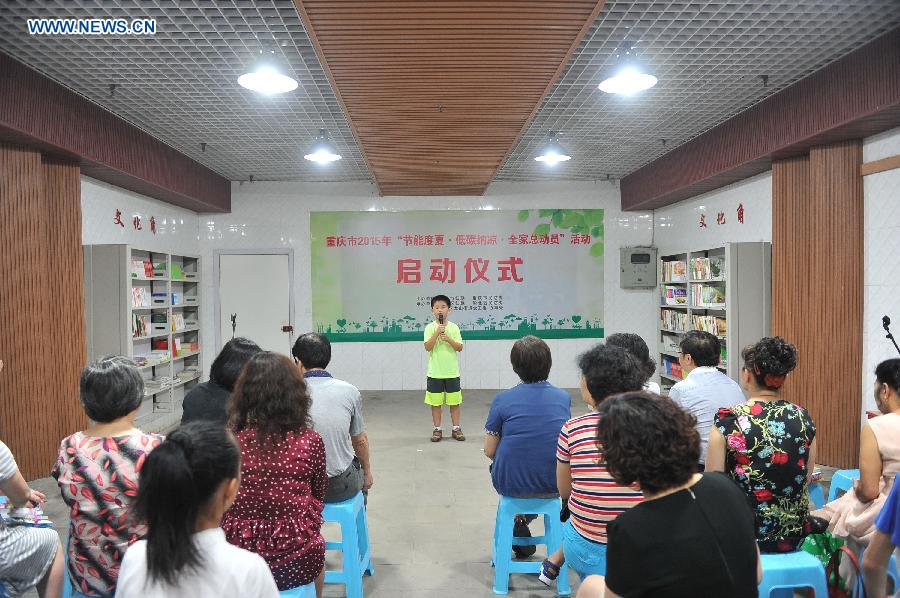 A boy tells stories when cooling off at a bomb shelter in Chongqing, southwest China, July 9, 2015.