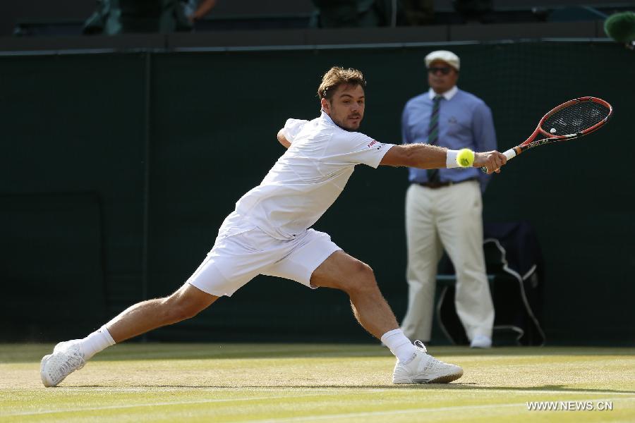 Stan Wawrinka of Switzerland servess a ball during men's quarterfinal match against Richard Gasquet of France at the 2015 Wimbledon Championships in Wimbledon, southwest London, July 8, 2015. Gasquet won the game 6-4, 4-6, 3-6, 6-4 and 11-9. (Xinhua/Ye Pingfan)