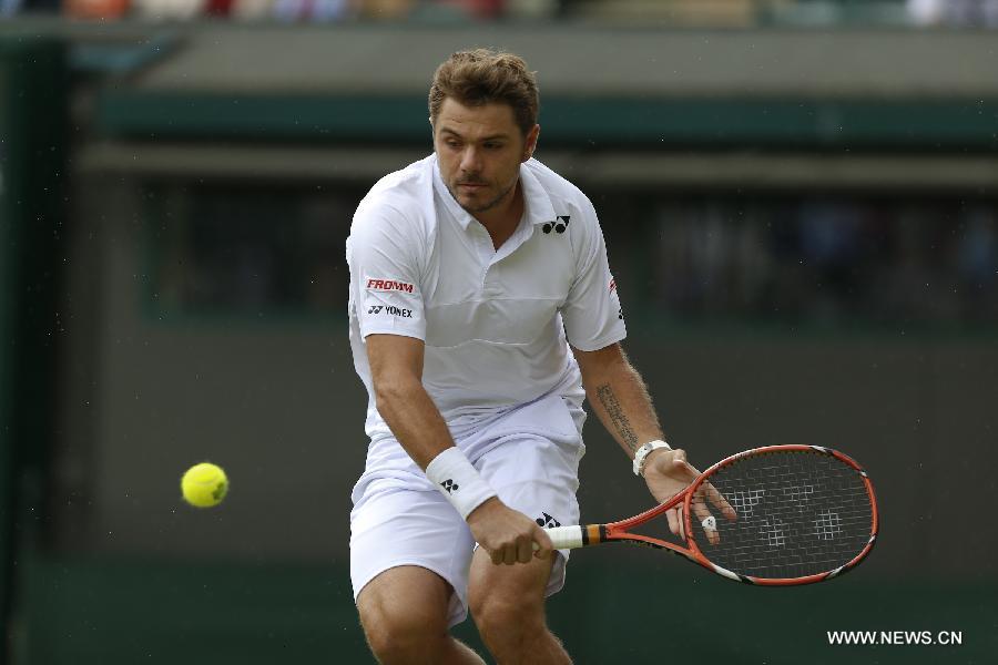 Stan Wawrinka of Switzerland servess a ball during men's quarterfinal match against Richard Gasquet of France at the 2015 Wimbledon Championships in Wimbledon, southwest London, July 8, 2015. Gasquet won the game 6-4, 4-6, 3-6, 6-4 and 11-9. (Xinhua/Ye Pingfan)