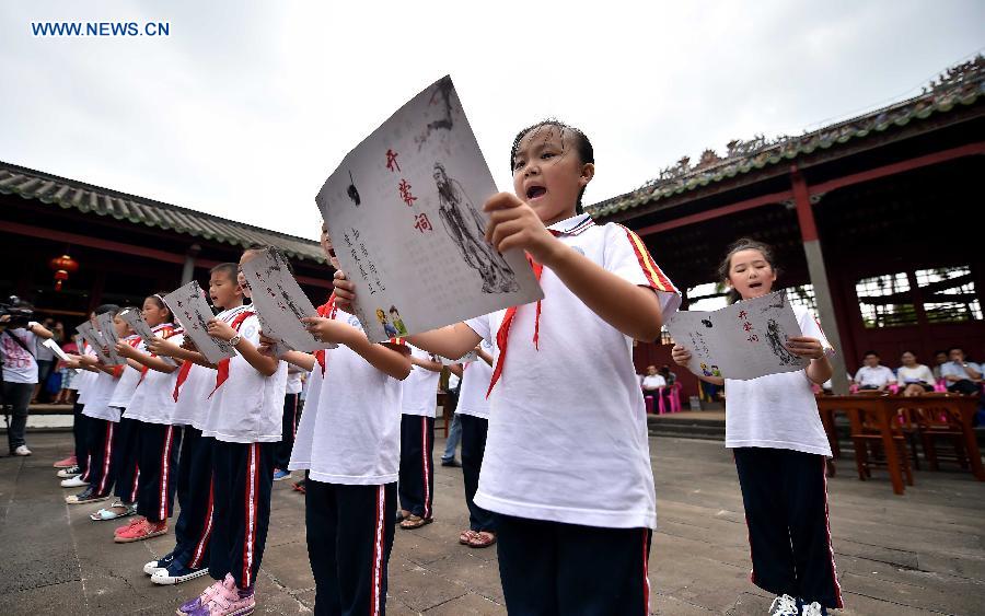 Students recite during the opening ceremony at the Confucius classroom in the Confucius Temple of Wenchang, south China's Hainan Province, July 10, 2015.