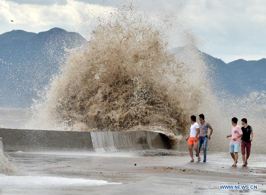 People dodge waves in Sansha Township of Xiapu, southeast China's Fujian Province, July 10, 2015. China is on highest alert as super typhoon Chan-Hom approaches the eastern coast at high speeds. 