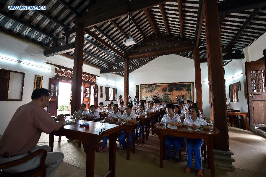 Students have a lesson at the Confucius classroom in the Confucius temple of Wenchang, south China's Hainan Province, July 10, 2015.