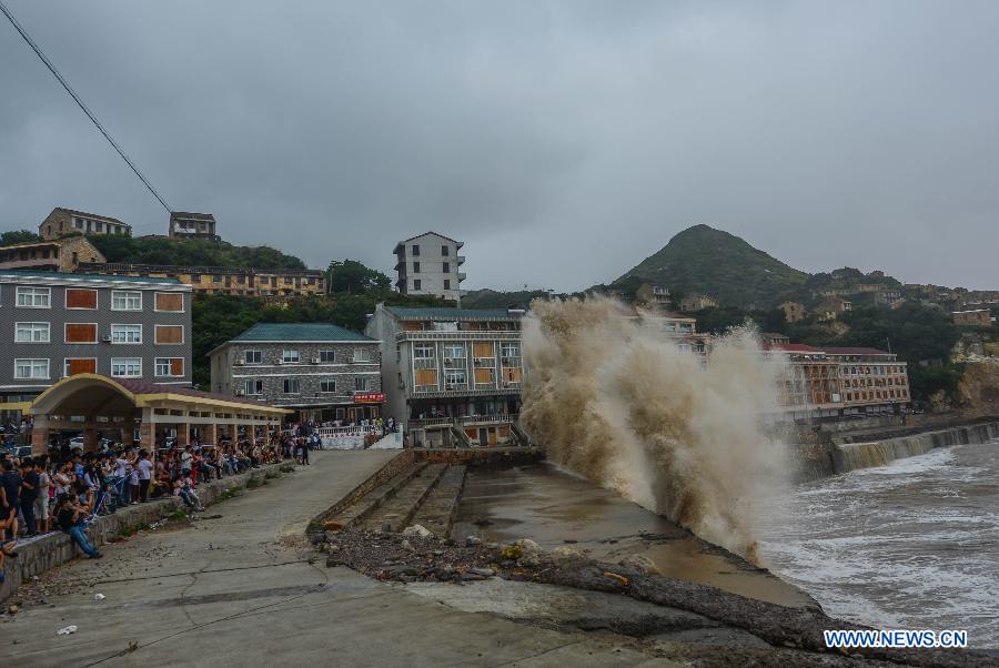 Turbulent sea waves hit the shore in San'ao Village of Wenling, east China's Zhejiang Province, July 10, 2015.