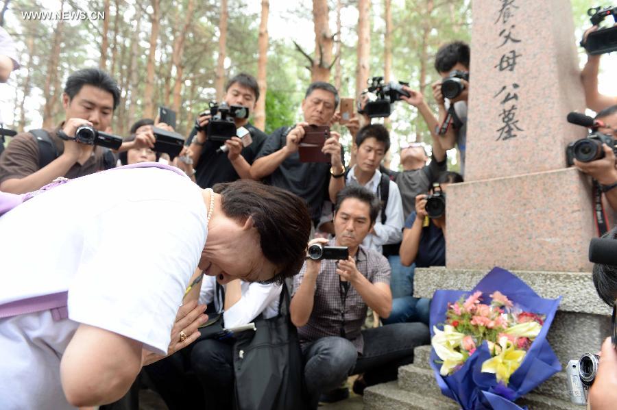 Japanese citizens, who were adopted by Chinese people during the World War II, visit a memorial hall as they visit a cemetery to memorize adoptive Chinese parents in Fangzheng County near Harbin, capital of northeast China's Heilongjiang Province, July 13, 2015. 