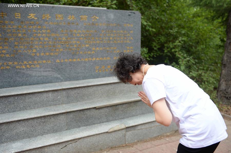 Japanese citizens, who were adopted by Chinese people during the World War II, visit a memorial hall as they visit a cemetery to memorize adoptive Chinese parents in Fangzheng County near Harbin, capital of northeast China's Heilongjiang Province, July 13, 2015. 