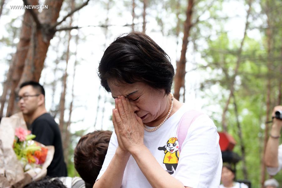 Japanese citizens, who were adopted by Chinese people during the World War II, visit a memorial hall as they visit a cemetery to memorize adoptive Chinese parents in Fangzheng County near Harbin, capital of northeast China's Heilongjiang Province, July 13, 2015. 