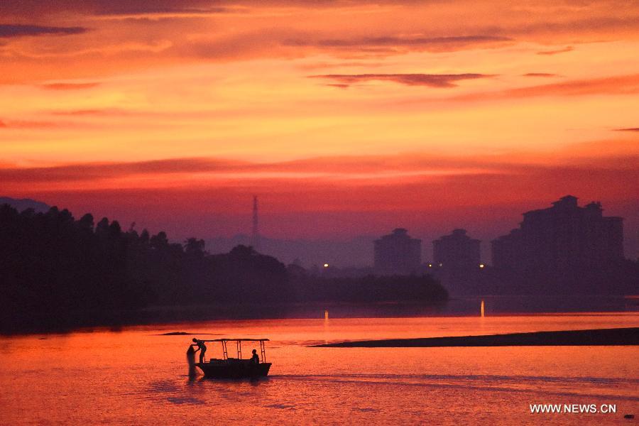 Fisherman fish on the Wanquan River in Qionghai of south China's Hainan Province, July 13, 2015.