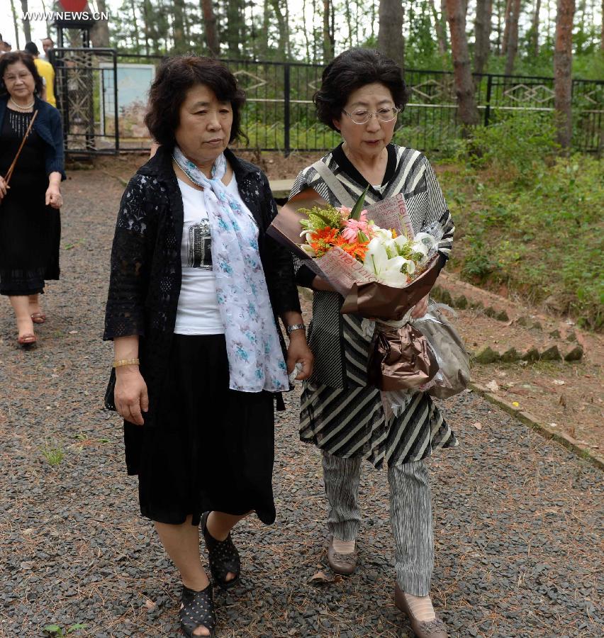 Japanese citizens, who were adopted by Chinese people during the World War II, visit a memorial hall as they visit a cemetery to memorize adoptive Chinese parents in Fangzheng County near Harbin, capital of northeast China's Heilongjiang Province, July 13, 2015. 