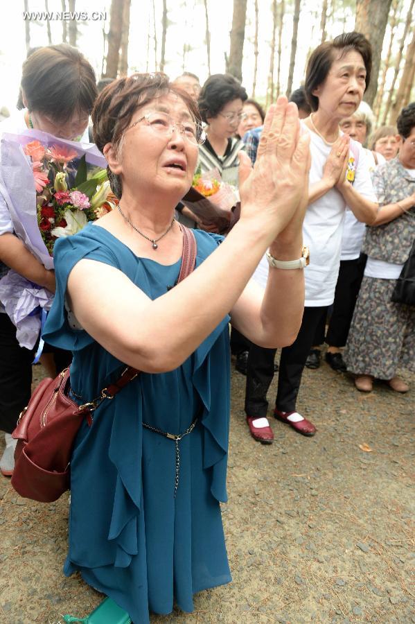 Japanese citizens, who were adopted by Chinese people during the World War II, visit a memorial hall as they visit a cemetery to memorize adoptive Chinese parents in Fangzheng County near Harbin, capital of northeast China's Heilongjiang Province, July 13, 2015. 