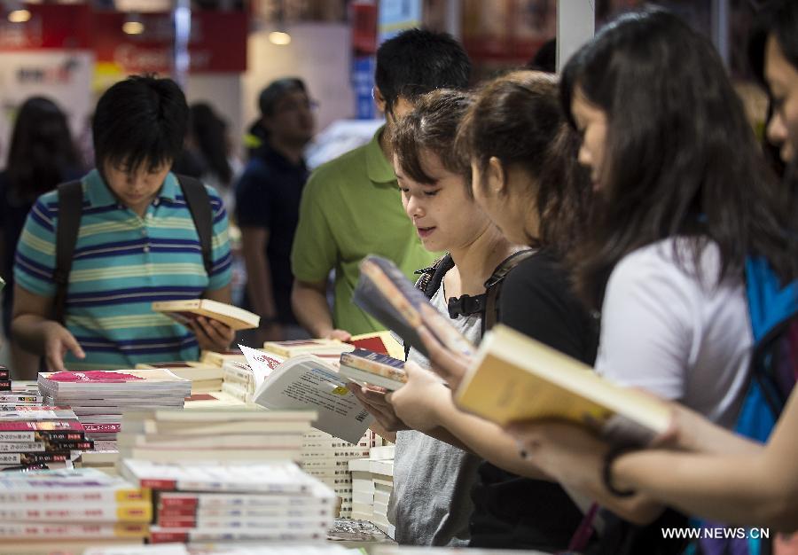 Citizens read books at the Hong Kong Book Fair in Hong Kong Convention and Exhibition Center in Hong Kong, south China, July 15, 2015.