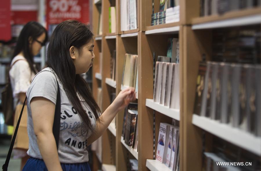 Citizens choose books at the Hong Kong Book Fair in Hong Kong Convention and Exhibition Center in Hong Kong, south China, July 15, 2015. 