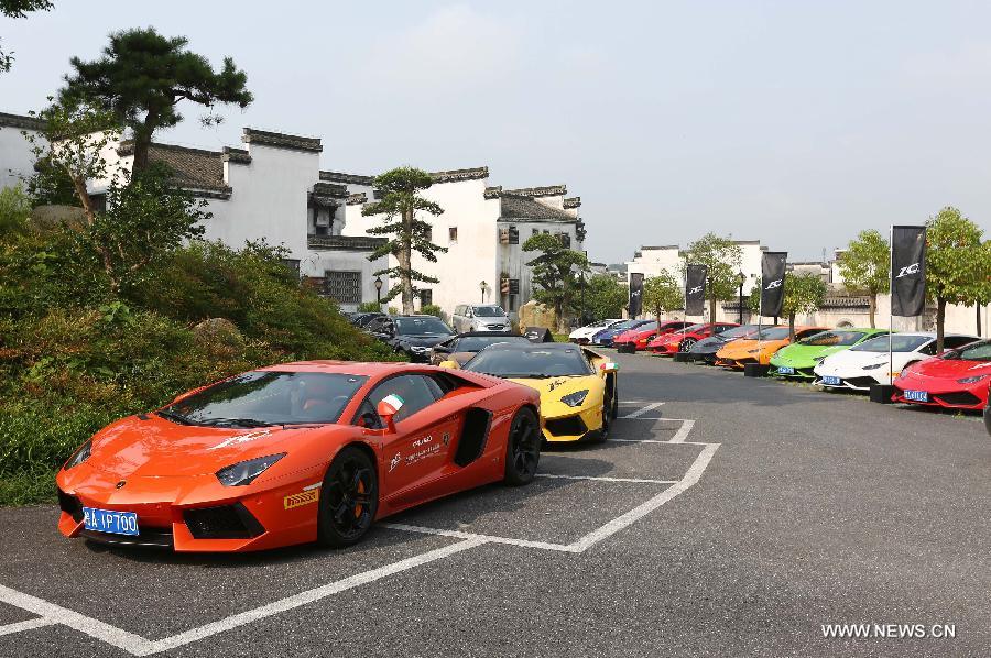 Lamborghini supercars arrive at Huizhou ancient town during a cruise in Huangshan, east China's Anhui Province, July 14, 2015.