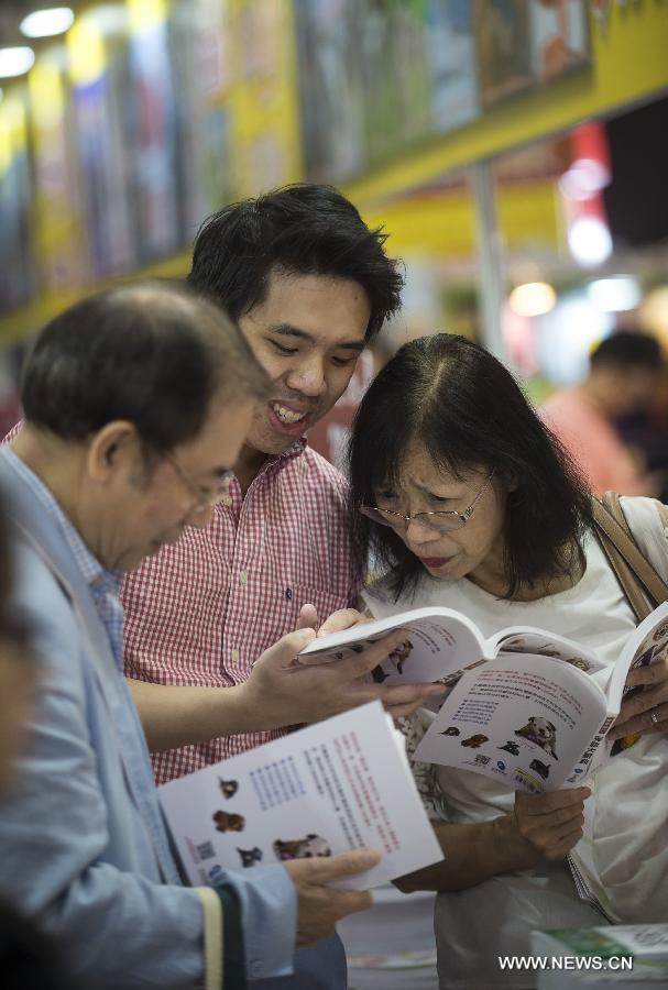 Citizens read books at the Hong Kong Book Fair in Hong Kong Convention and Exhibition Center in Hong Kong, south China, July 15, 2015.