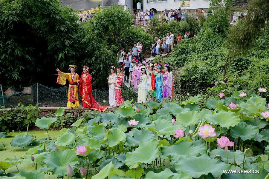 Actors dressed as an ancient imperial family are seen at a local lotus festival at Yangling Village in Neijiang City, southwest China's Sichuan Province, July 16, 2015.