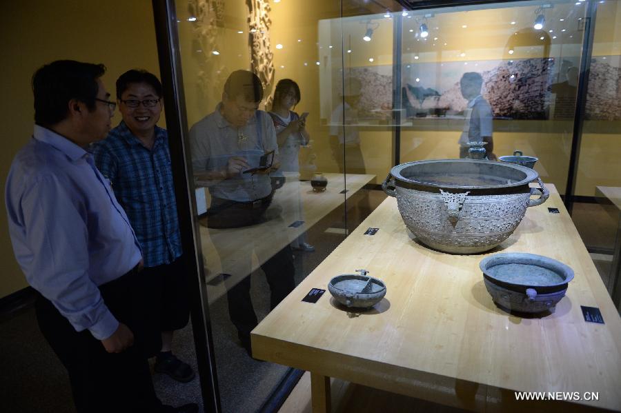 Spectators visit a historic and cultural exhibiton of Qi(1046BC-221BC), an ancient Chinese state during the Zhou Dynasty of ancient China, in Xi'an, capital of northwest China's Shaanxi Province, July 16, 2015.