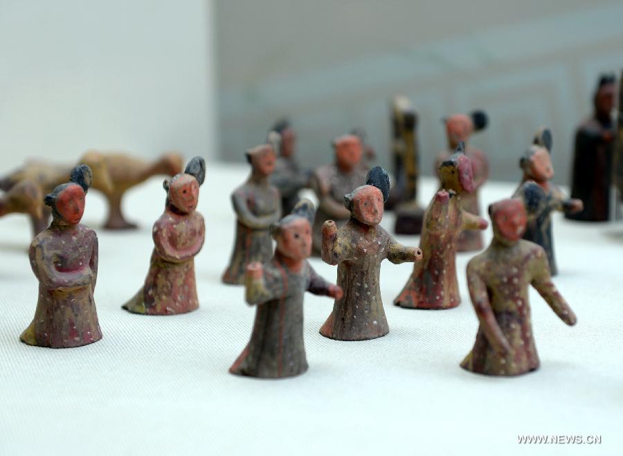 Photo taken on July 16, 2015 shows a group pf colored pottery figurines during a historic and cultural exhibiton of Qi(1046BC-221BC), an ancient Chinese state during the Zhou Dynasty of ancient China, in Xi'an, capital of northwest China's Shaanxi Province.