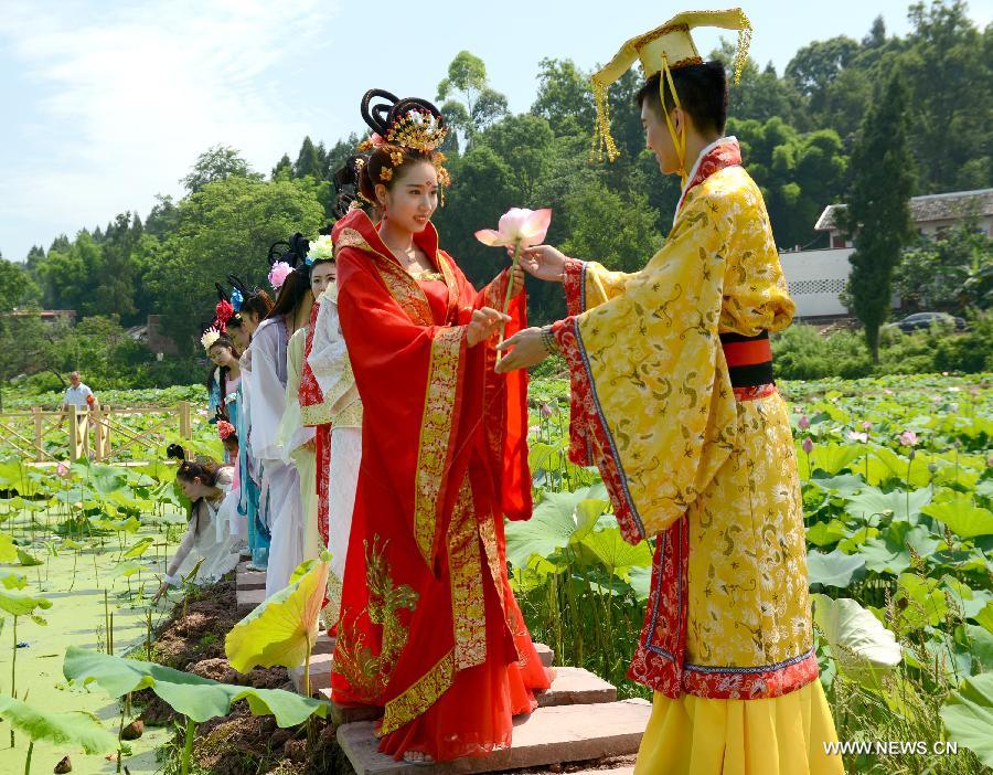 Actors dressed as an ancient imperial family are seen at a local lotus festival at Yangling Village in Neijiang City, southwest China's Sichuan Province, July 16, 2015.