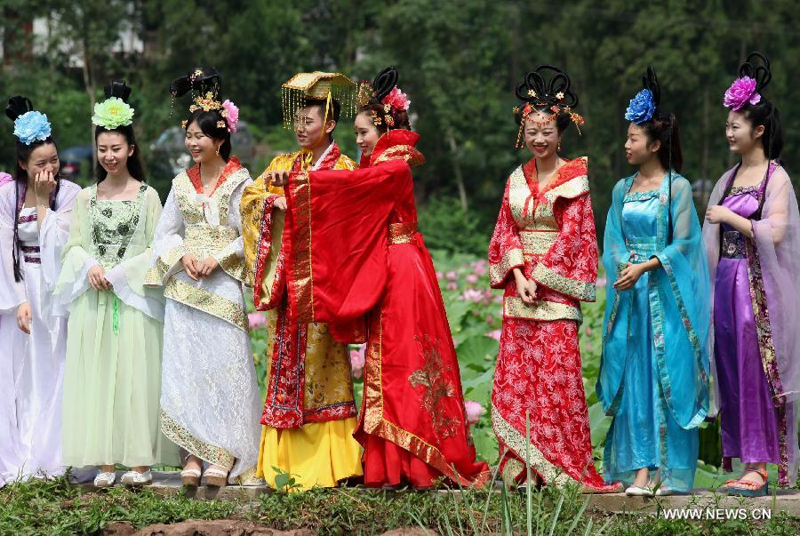 Actors dressed as an ancient imperial family are seen at a local lotus festival at Yangling Village in Neijiang City, southwest China's Sichuan Province, July 16, 2015.