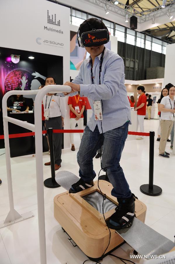 A visitor experiences a skiing machine which is based on the 5G mobile communication technology during the Mobile World Congress Shanghai in Shanghai, east China, July 17, 2015.