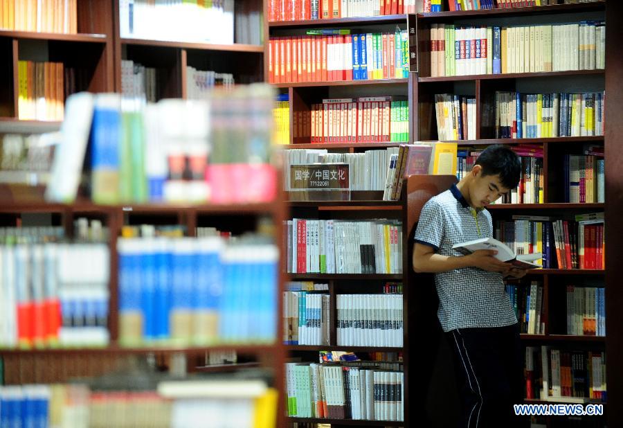 Readers read at a bookstore in Shenyang, capital of northeast China's Liaoning Province, July 16, 2015. Bookstores with cool and comfortable environment have provided a good place for people to read during the days when heat wave hit Shenyang. (Xinhua/Zhang Wenkui) 