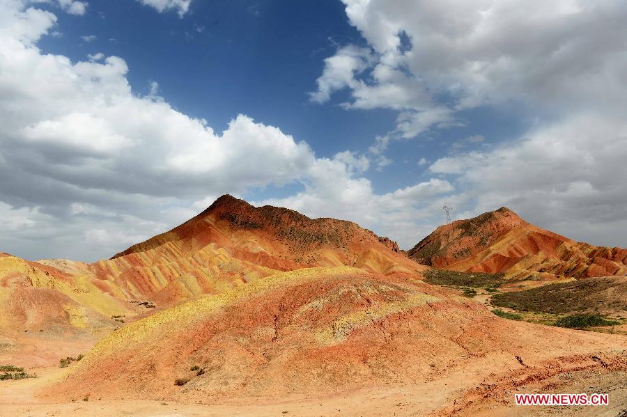 People visit the Danxia landform at the Zhangye Danxia National Geological Park in Zhangye, northwest China's Gansu Province, July 16, 2015. (Xinhua/Qiao Qiming) 