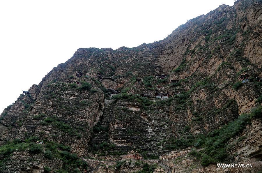 Photo taken on July 20, 2015 shows ancient Taoist temples built on the cliff in Sanggan River canyon in Xuanhua County, north China's Hebei Province.