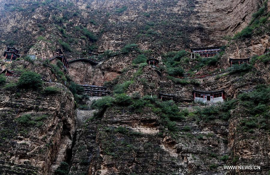 Photo taken on July 20, 2015 shows ancient Taoist temples built on the cliff in Sanggan River canyon in Xuanhua County, north China's Hebei Province.